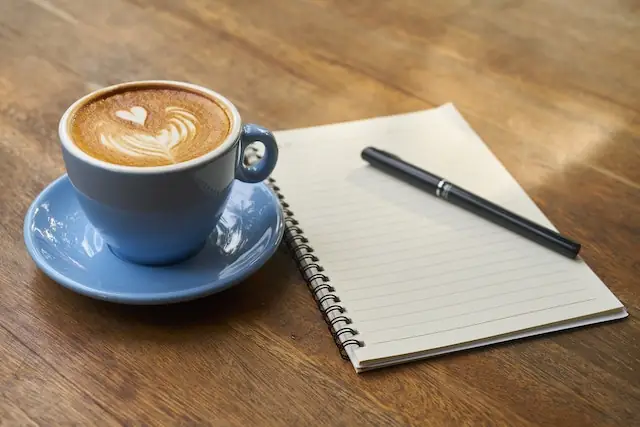coffee cup and notepad meeting